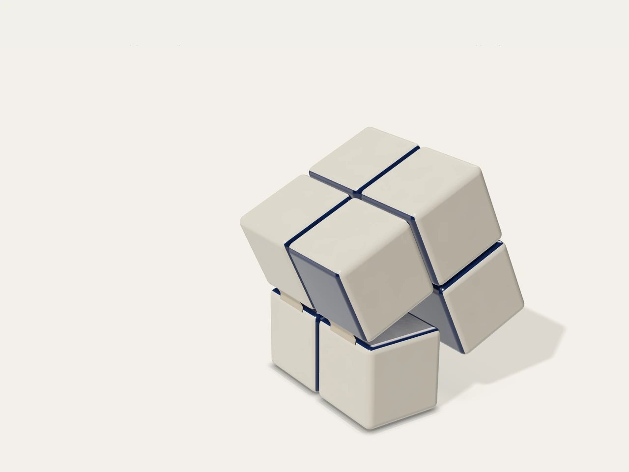 A folding cube of rounded warm porcelain blocks, opening to reveal ink-blue glazed faces.